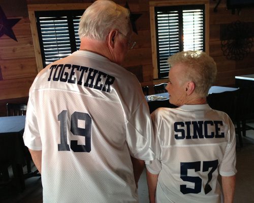 A man and boy wearing matching jerseys with the number 1 9 on them.