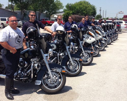 A group of men standing next to motorcycles.