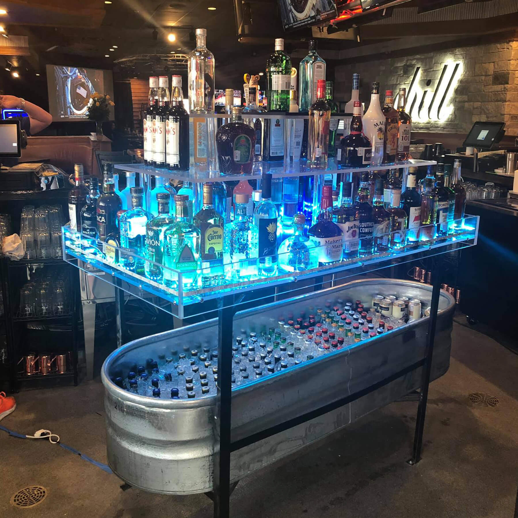 A bar with many bottles of alcohol on top